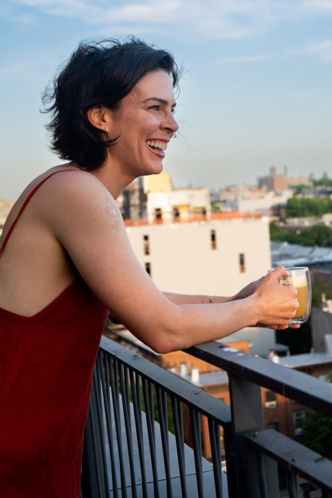 Cara Morning Lover Founder standing over balcony